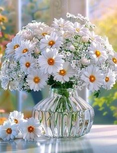 a vase filled with white daisies sitting on top of a table