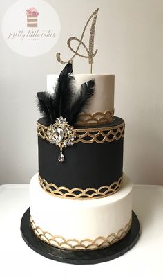 a black and white cake with gold accents