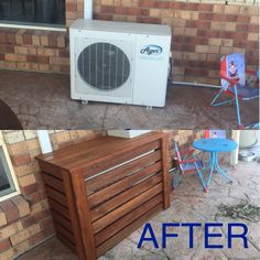 an air conditioner sitting on the side of a building next to a table and chairs