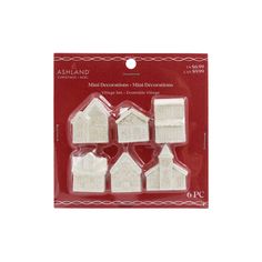 four small white houses in plastic packaging