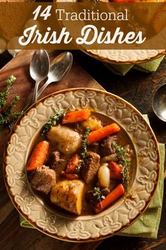 a bowl filled with stew and carrots on top of a wooden table next to other dishes