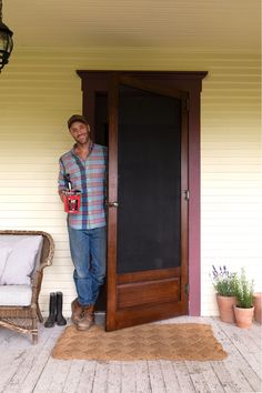 a man standing in front of a wooden door