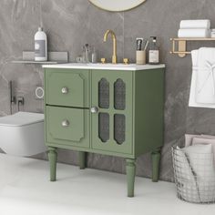 a bathroom with a sink, toilet and green cabinet in front of a mirror on the wall