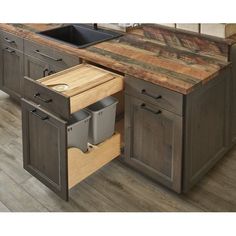 an open drawer in the middle of a kitchen counter with a sink and dishwasher