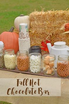 a table topped with jars filled with different types of candy and marshmallows