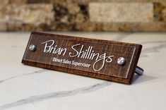 a wooden sign that says bran shillings direct sales supervisor on the front of it