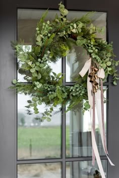 a wreath is hanging on the front door