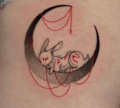 a rabbit is sitting on the moon with an arrow in it's back tattoo