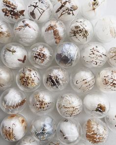 many different types of glass balls with dirt on them