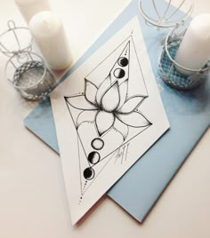 a card with an image of a flower and three candles on it next to each other