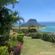 the words heal, learn, grow, love are displayed in front of an ocean view