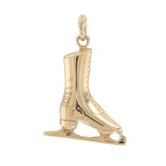 a gold charm that has a pair of ice skates on the front and bottom