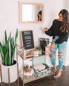 a woman standing in front of a mirror with an instagram