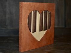 a wooden block with a heart cut out of it