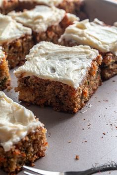 carrot cake with cream cheese frosting on a baking sheet, ready to be eaten