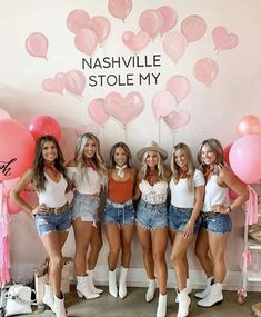 the girls are posing with their pink balloons