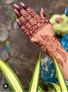 a woman's hand with henna on it