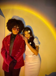 two people dressed in costumes posing for the camera