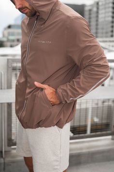 The Prime Windbreaker is the perfect layering piece to throw on top of your favorite outfit. This jacket offers functionality and comfort while also providing a sporty look to add to your wardrobe. Sporty Brown Long Sleeve Tops, Brown Long Sleeve Sporty Tops, Functional Long Sleeve Go-dry Outerwear, Athleisure Windbreaker With Pockets For Gym, Sporty Khaki Track Jacket For Streetwear, Urban Moisture-wicking Activewear For Fall, Sporty Khaki Nylon Outerwear, Long Sleeve Windbreaker With Pockets For Workout, Urban Stretch Outerwear With Long Sleeves