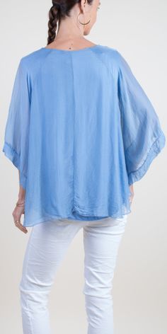 Round Neck Silk Top with 3/4 Length Bell Sleeves. Features a 100% Silk Exterior Layer and a Soft Viscose Inner Lining. Exterior: 100% Silk Interior: 95% Viscose, 5% Elastic Made in Italy One Size Model is 5'7 Flowy Half Sleeve Blouse For Spring, Summer Half Sleeve Tops For Layering, Half-sleeve Tops For Summer Layering, Half Sleeve Tops For Summer Layering, Relaxed Fit Half Sleeve Top For Layering, Elegant Blue Half Sleeve Top, Blue Silk Short Sleeve Top, Blue Short Sleeve Silk Top, Versatile Silk Tops For Summer