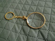 a close up of a key chain with a magnifying glass