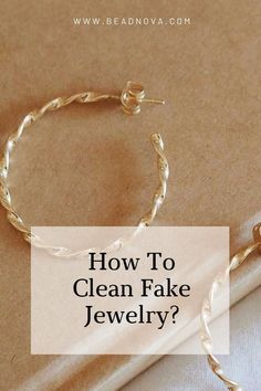 the words how to clean fake jewelry? on top of a white sheet with gold chains