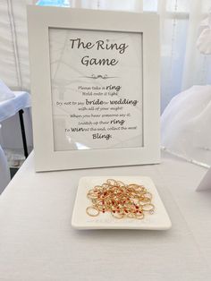 the ring game is displayed in front of a white plate with gold rings on it