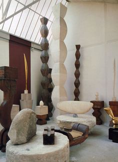 a room filled with lots of different types of sculptures and decor on top of each other