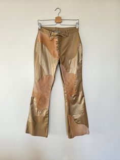 "Y2K Gold and Brown Faux Leather Boot Cut Patchwork Pants Label(s): Rave Additional Details: CUTE! MEASUREMENTS & SIZING: Women's Size 9 Waist: 28\" Hip: 36\" Length: 40\" Condition: Great Condition Meter Amazing: Hardly OR never worn/used Great: Wow! This piece had a happy home Good: Nothing too noticeable! Fair: Light visual wear but the item is in decent condition" Patchwork Pants, Faux Leather Boots, Womens Pants, Home Good, Happy Home, Leather Boot, Trousers Women, Boot Cut, Capri Pants