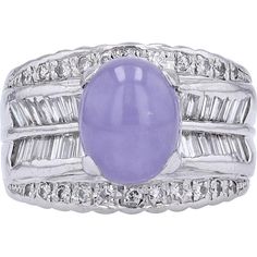 Enrich your collection with the timeless elegance of the Platinum 900 Lavender Jade & Diamond Ring, a stunning piece from the prestigious collection of fine jewelry. This exquisite ring features a captivating lavender jade main stone, weighing an impressive 3.34 Carats, exuding a delicate yet alluring hue that is sure to enchant. The lavender jade is beautifully complemented by a total of 1.17 Carats of dazzling diamonds, carefully set in platinum 900 to enhance their brilliance.Crafted with meticulous attention to detail, this ring boasts a design that captures the essence of sophistication and refinement. The intricate setting showcases the natural beauty of the lavender jade, while the sparkling diamonds add a touch of luxury and glamour. Whether worn as a statement piece or for a speci Luxury Lavender Amethyst Ring With Center Stone, Luxury Lavender Ring With Center Stone, Elegant Lavender Multi-stone Amethyst Ring, Elegant Lavender Multi-stone Jewelry, Elegant Lavender Jewelry With Center Stone, Luxury Lavender Round Ring, Formal Lavender Tanzanite Jewelry, Jade Diamond Ring, Lavender Jade