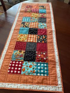 the table runner is made from patchwork fabric