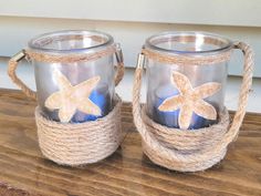 two glass mugs decorated with starfish and rope