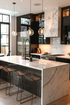 a kitchen with marble counter tops and stools in front of an island that has three lights hanging from it