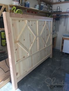 a large wooden cabinet sitting inside of a garage