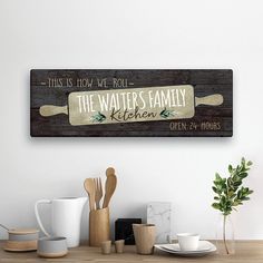 this is how we roll the waiter's family kitchen sign on a wooden table