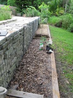 the garden is ready to be planted next to the fenced in area that's being used as a planter