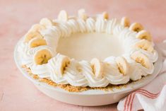 a banana cream pie sitting on top of a white plate