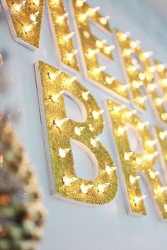 the words happy birthday are lit up in gold and white letters with stars on them