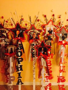 a bunch of red and white decorations hanging on the wall next to each other in front of a yellow wall