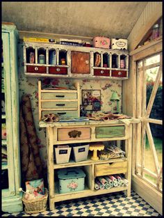 an old fashioned desk with drawers and baskets on it in a room that has a checkerboard floor