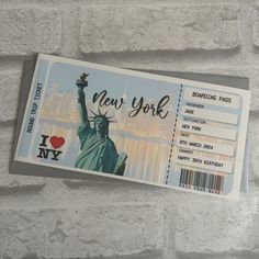 the new york city bus ticket is hanging on a brick wall with an i love ny sticker