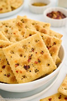 some crackers are in a white bowl on a table