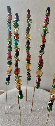 several different colored glass beads are on top of each other in the shape of spirals