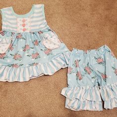 New In Package. Blue Floral Ruffle Shorts Outfit. Runs Generous To Size Marked. Top Has Pockets.. Sizes Available: 6-12 Month, 12-18 Month, 2t, 3t, 5-6, 6-7. 95% Cotton, 5% Spandex. Soft Material. Blue Ruffled Bloomers For Summer, Summer Blue Ruffled Bloomers, Blue Cotton Ruffle Sets, Blue Cotton Ruffled Sets, Blue Cotton Bloomers With Ruffles, Playful Blue Ruffled Bottoms, Cute Blue Summer Bloomers, Cute Ruffled Bottoms For Playwear, Light Blue Ruffled Sets For Summer