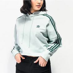 Adidas Keeps You Looking Effortlessly Cool In The New Cropped Hoodie. This Everyday Pullover Boasts Long Sleeves With The Iconic 3-Stripes, A Drawstring Hood, Adidas Trefoil Embroidery At The Left Chest, And A Cropped Fit. Solid Color Hoodie Drawstring Hood Long Sleeves 3-Stripes Trefoil Embroidery Cropped Length Color: Vapour Green Green Cropped Hoodie, Hoodie Zumiez, Long Shirt Women, Adidas Cropped Hoodie, Jogger Pants Outfit, Adidas Trefoil, Adidas Outfit, Crop Hoodie, Sporty Outfits