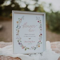 a flower bar sign sitting on top of a table