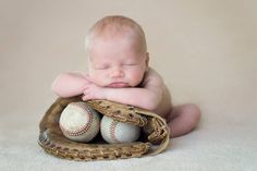 a baby is laying in a baseball mitt