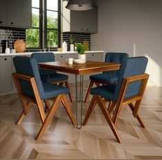 a wooden table with four blue chairs around it and a kitchen area in the background