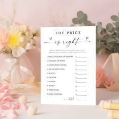 the price is right sign next to some flowers and other items on a white table