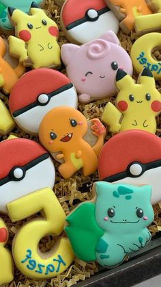 decorated cookies in the shape of pokemons and pikachu's on display